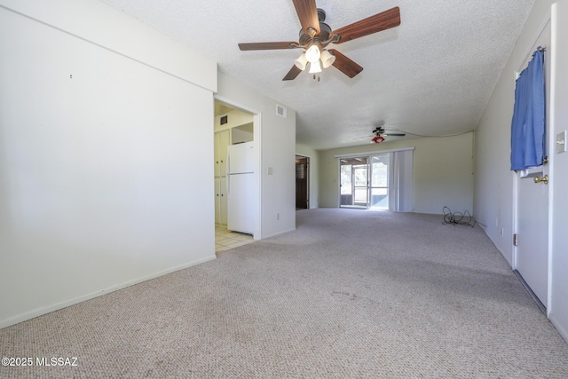 unfurnished room featuring carpet, a ceiling fan, and a textured ceiling