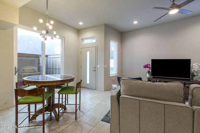 living area featuring ceiling fan with notable chandelier, baseboards, recessed lighting, and light tile patterned floors