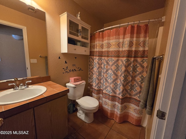 1702 E Saint Bernadine St, Tucson, AZ 85713 - bathroom with toilet, vanity, tile patterned flooring, a textured wall, and curtained shower