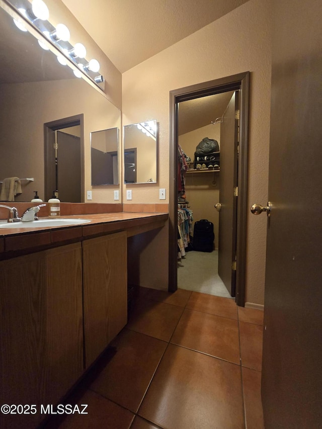 1702 E Saint Bernadine St, Tucson, AZ 85713 - bathroom with tile patterned floors, vanity, and a spacious closet