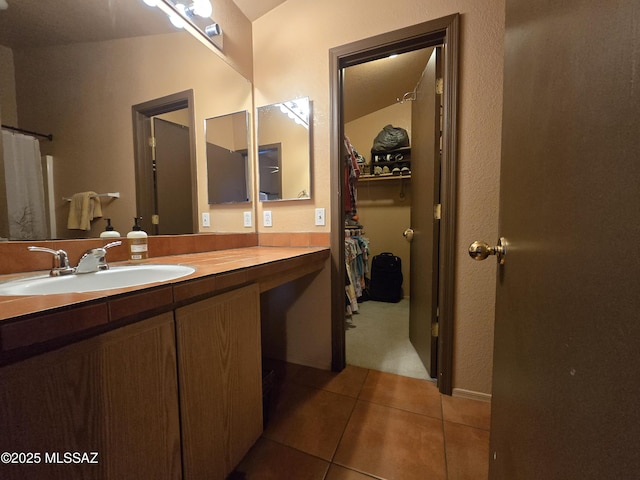 1702 E Saint Bernadine St, Tucson, AZ 85713 - full bath featuring tile patterned floors, vanity, and a walk in closet