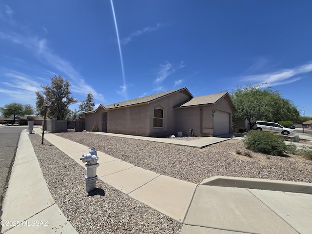 1702 E Saint Bernadine St, Tucson, AZ 85713 - view of home's exterior featuring a garage and stucco siding