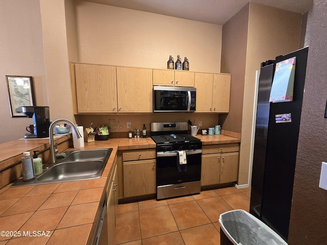 1702 E Saint Bernadine St, Tucson, AZ 85713 - kitchen featuring appliances with stainless steel finishes, tile counters, light brown cabinets, a sink, and light tile patterned floors
