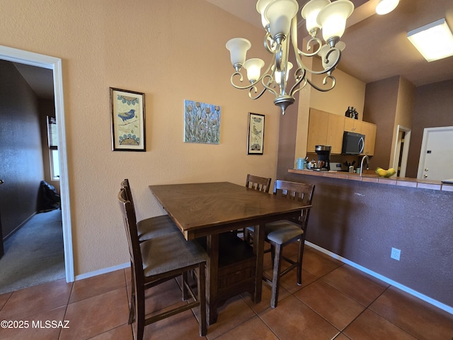 1702 E Saint Bernadine St, Tucson, AZ 85713 - tiled dining space with a chandelier, a sink, and baseboards