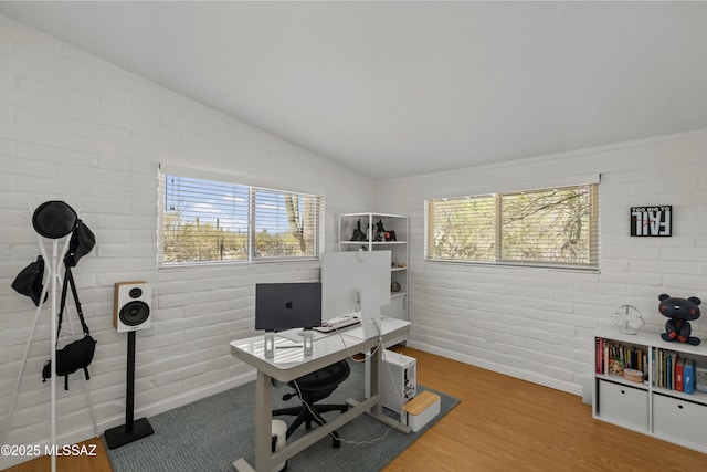 6530 N Camino De La Karina, Tucson, AZ 85718 - office area featuring plenty of natural light, baseboards, vaulted ceiling, wood finished floors, and brick wall