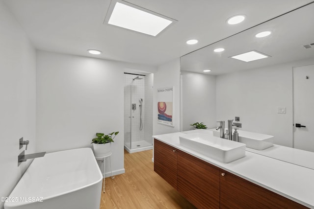 6530 N Camino De La Karina, Tucson, AZ 85718 - bathroom with a shower stall, wood finished floors, vanity, recessed lighting, and a freestanding bath