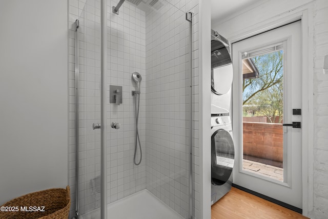 6530 N Camino De La Karina, Tucson, AZ 85718 - full bathroom featuring estacked washer and dryer, a shower stall, and wood finished floors