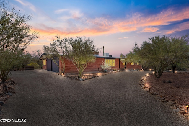 6530 N Camino De La Karina, Tucson, AZ 85718 - view of front facade featuring driveway, brick siding, and an attached garage