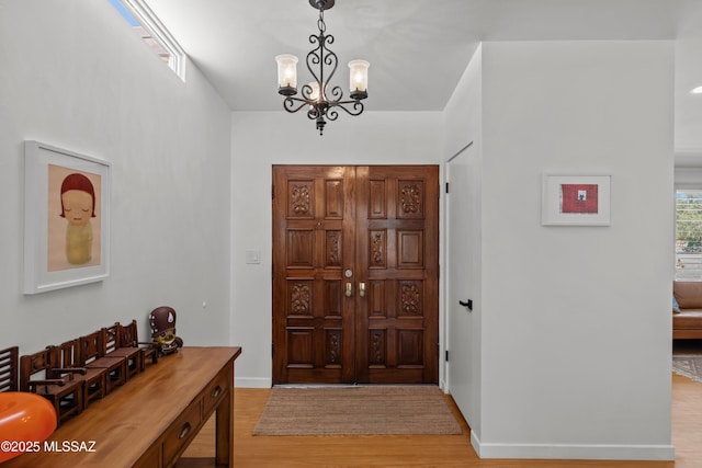 6530 N Camino De La Karina, Tucson, AZ 85718 - entrance foyer with light wood-type flooring, baseboards, and a chandelier