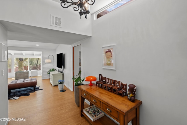 6530 N Camino De La Karina, Tucson, AZ 85718 - foyer featuring a chandelier, wood finished floors, baseboards, and a high ceiling