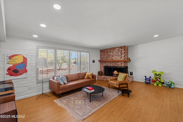 6530 N Camino De La Karina, Tucson, AZ 85718 - living room with wood finished floors, a fireplace, baseboards, and brick wall
