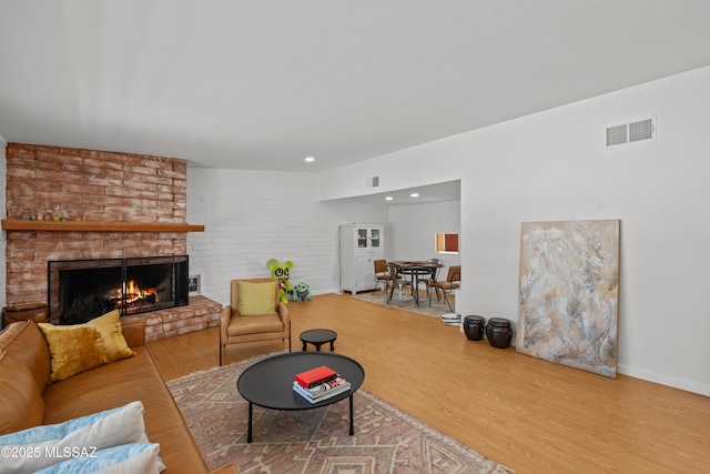 6530 N Camino De La Karina, Tucson, AZ 85718 - living room featuring a brick fireplace, wood finished floors, baseboards, and recessed lighting