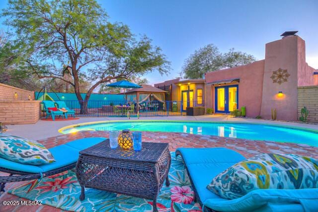 view of pool featuring fence, a fenced in pool, and a patio