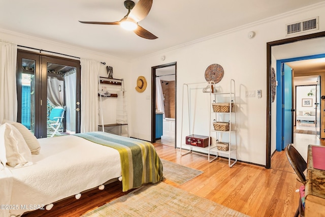 bedroom featuring access to exterior, light wood finished floors, visible vents, ornamental molding, and ensuite bath