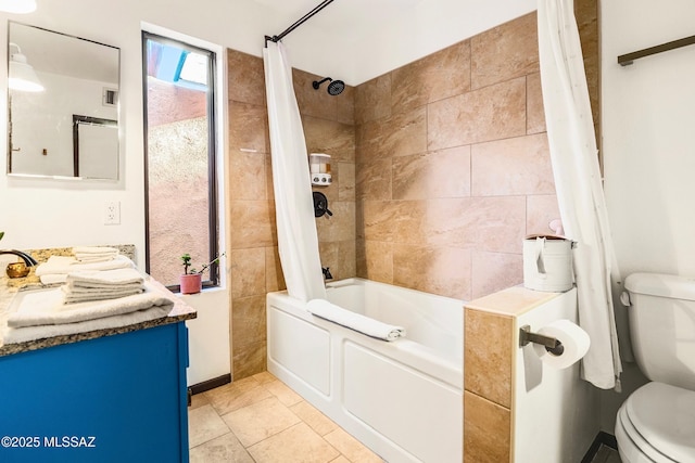 full bathroom featuring vanity, shower / bath combo with shower curtain, toilet, and tile patterned floors