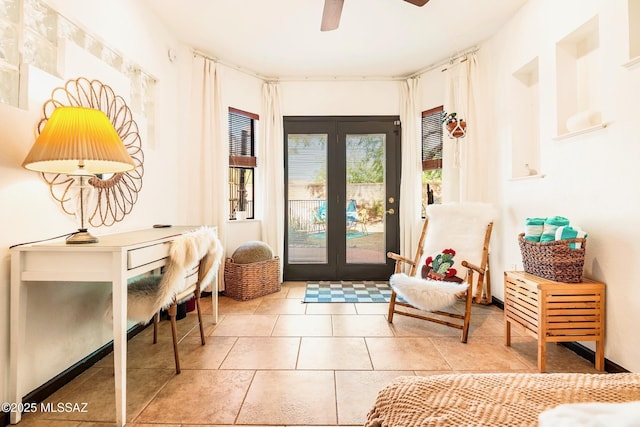 entryway with tile patterned flooring, a ceiling fan, and french doors