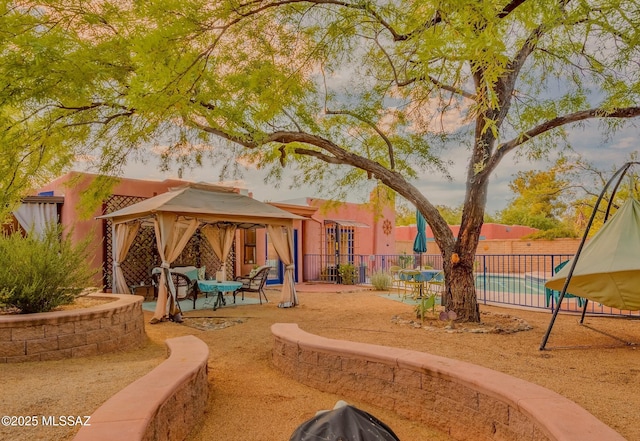 exterior space with a gazebo, a patio, and fence