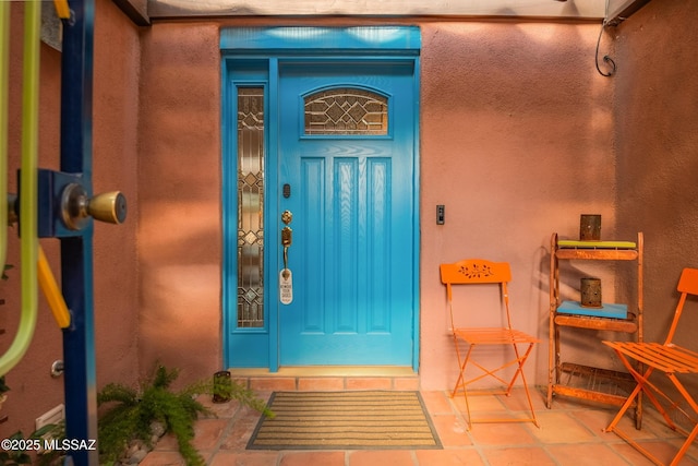 entrance to property with stucco siding