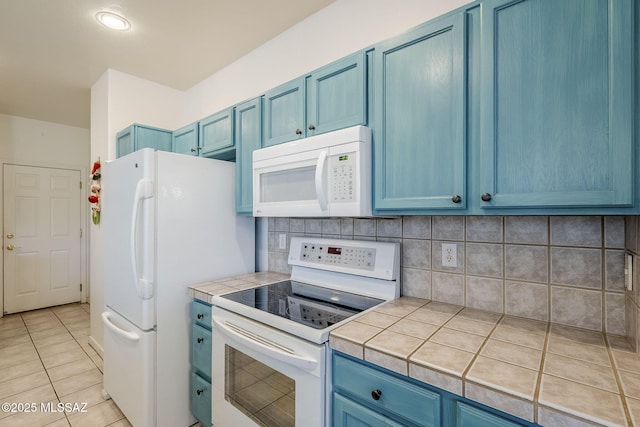 kitchen featuring blue cabinetry, decorative backsplash, white appliances, and tile countertops