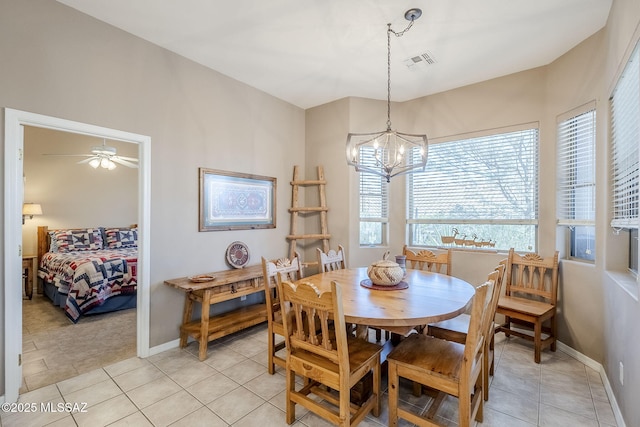 dining area with light tile patterned floors, visible vents, a chandelier, and baseboards