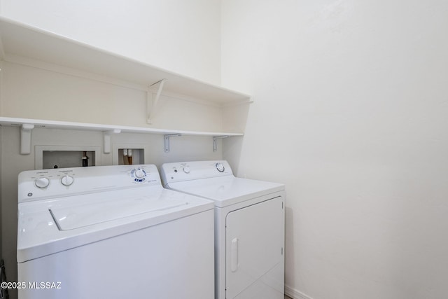 clothes washing area featuring washing machine and dryer and laundry area