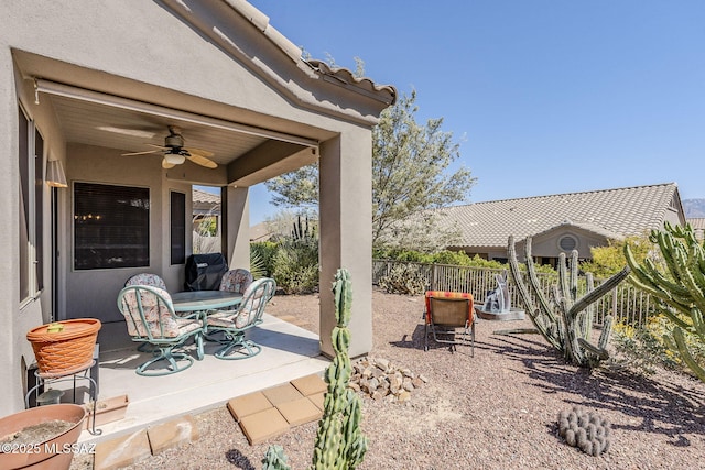 view of patio / terrace featuring a ceiling fan, outdoor dining area, and fence