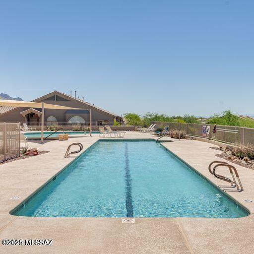 pool featuring a patio area and fence