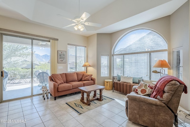 living room featuring light tile patterned floors and ceiling fan