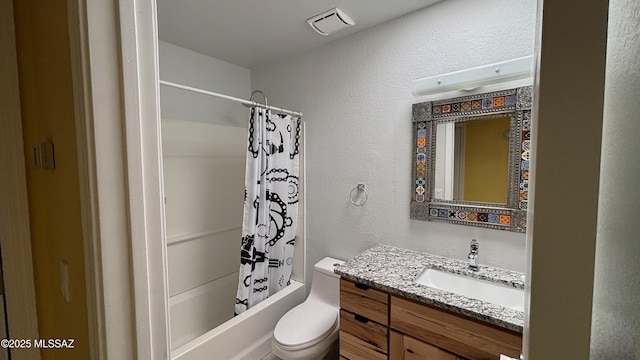 full bath with visible vents, shower / tub combo with curtain, toilet, vanity, and a textured wall