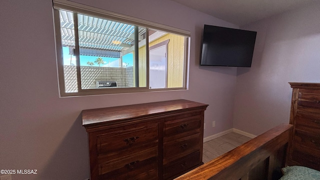 bedroom with baseboards and light wood finished floors