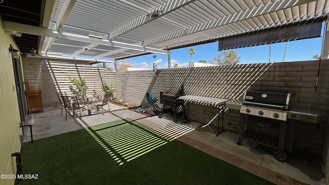 view of patio / terrace featuring area for grilling, fence, and a pergola