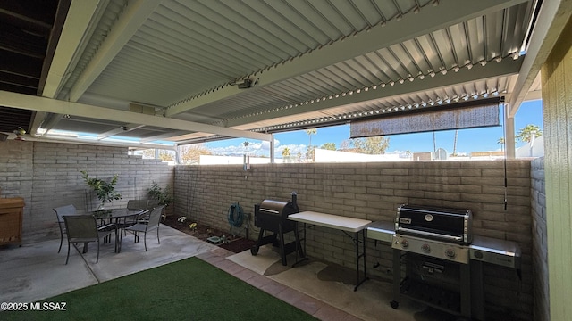 view of patio / terrace featuring a grill, outdoor dining area, and fence