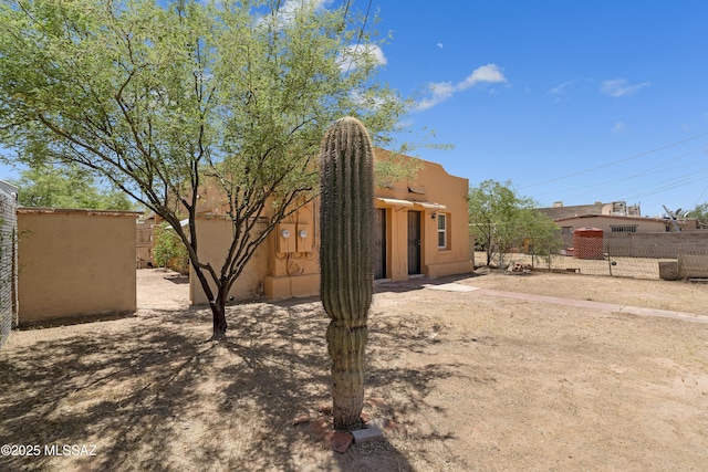 exterior space with fence and stucco siding