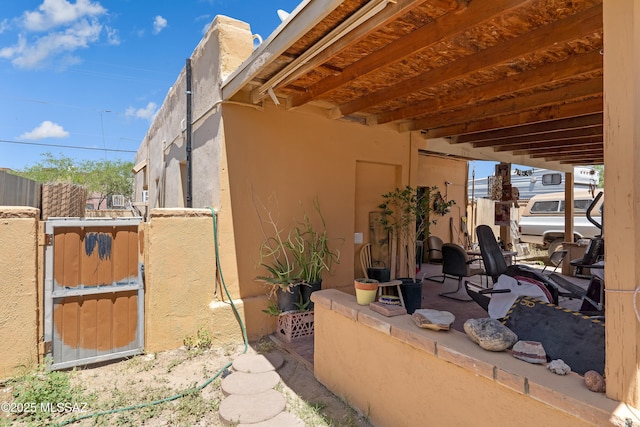 view of property exterior featuring fence and stucco siding