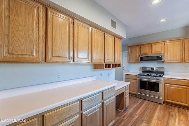 kitchen featuring light countertops, visible vents, appliances with stainless steel finishes, and wood finished floors
