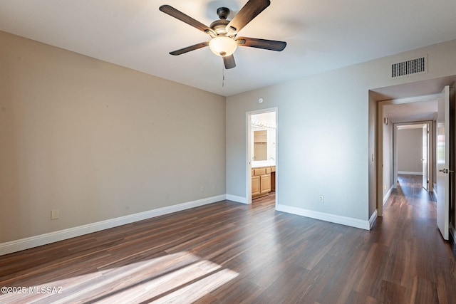 unfurnished room with dark wood-style floors, baseboards, ceiling fan, and visible vents