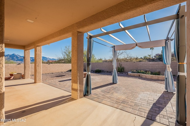 view of patio / terrace featuring a fenced backyard and a mountain view