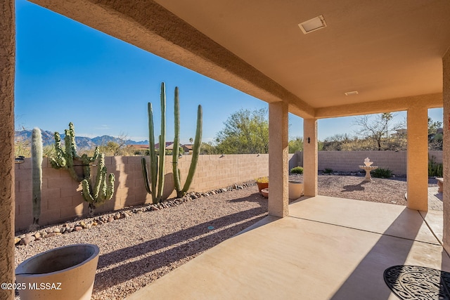 view of patio with a fenced backyard and a mountain view
