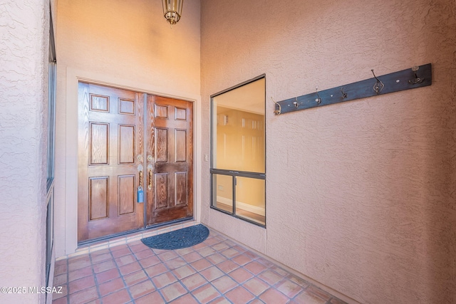 entrance to property with stucco siding