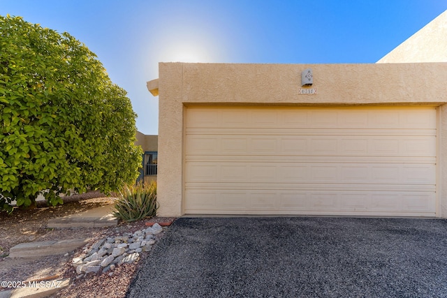 garage with aphalt driveway