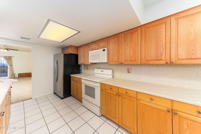 kitchen featuring visible vents, white appliances, and light countertops