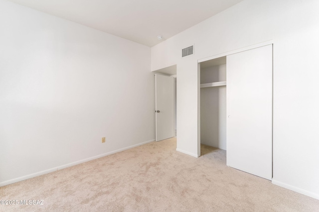 unfurnished bedroom with a closet, visible vents, baseboards, and carpet floors