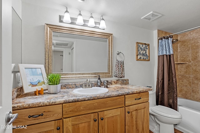 full bathroom with vanity, shower / tub combo, toilet, and visible vents