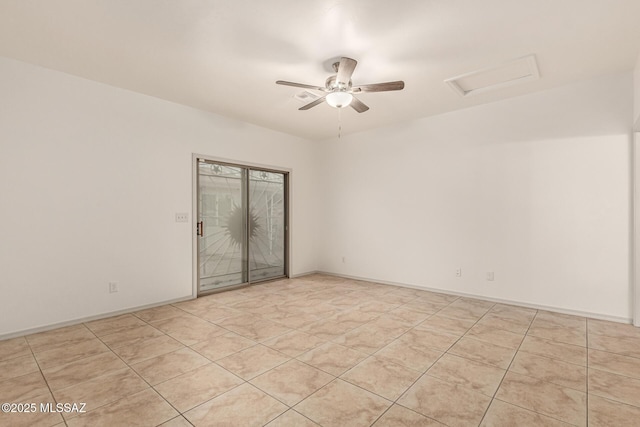 empty room with a ceiling fan, baseboards, and attic access