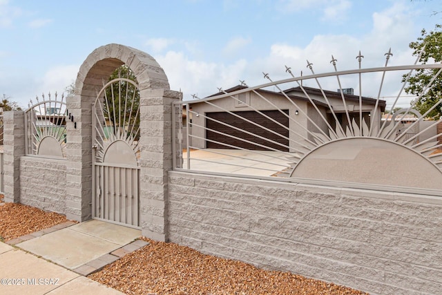 view of gate with a fenced front yard
