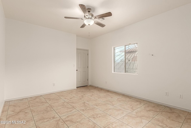 spare room featuring baseboards and ceiling fan