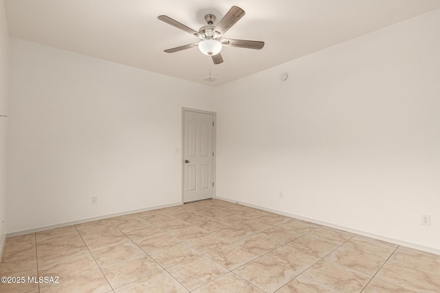 spare room with baseboards and ceiling fan