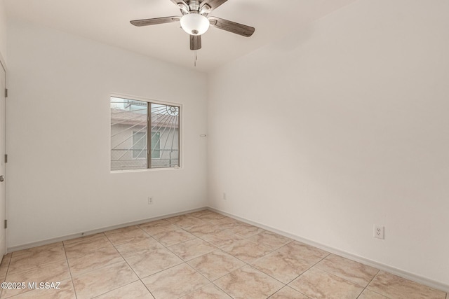 empty room featuring a ceiling fan, light tile patterned floors, and baseboards