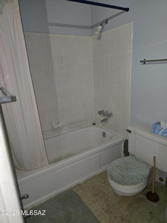 bathroom featuring shower / bath combo and toilet