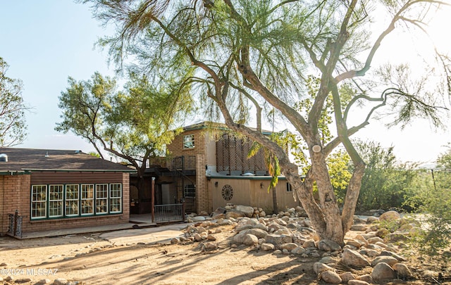 back of house featuring brick siding